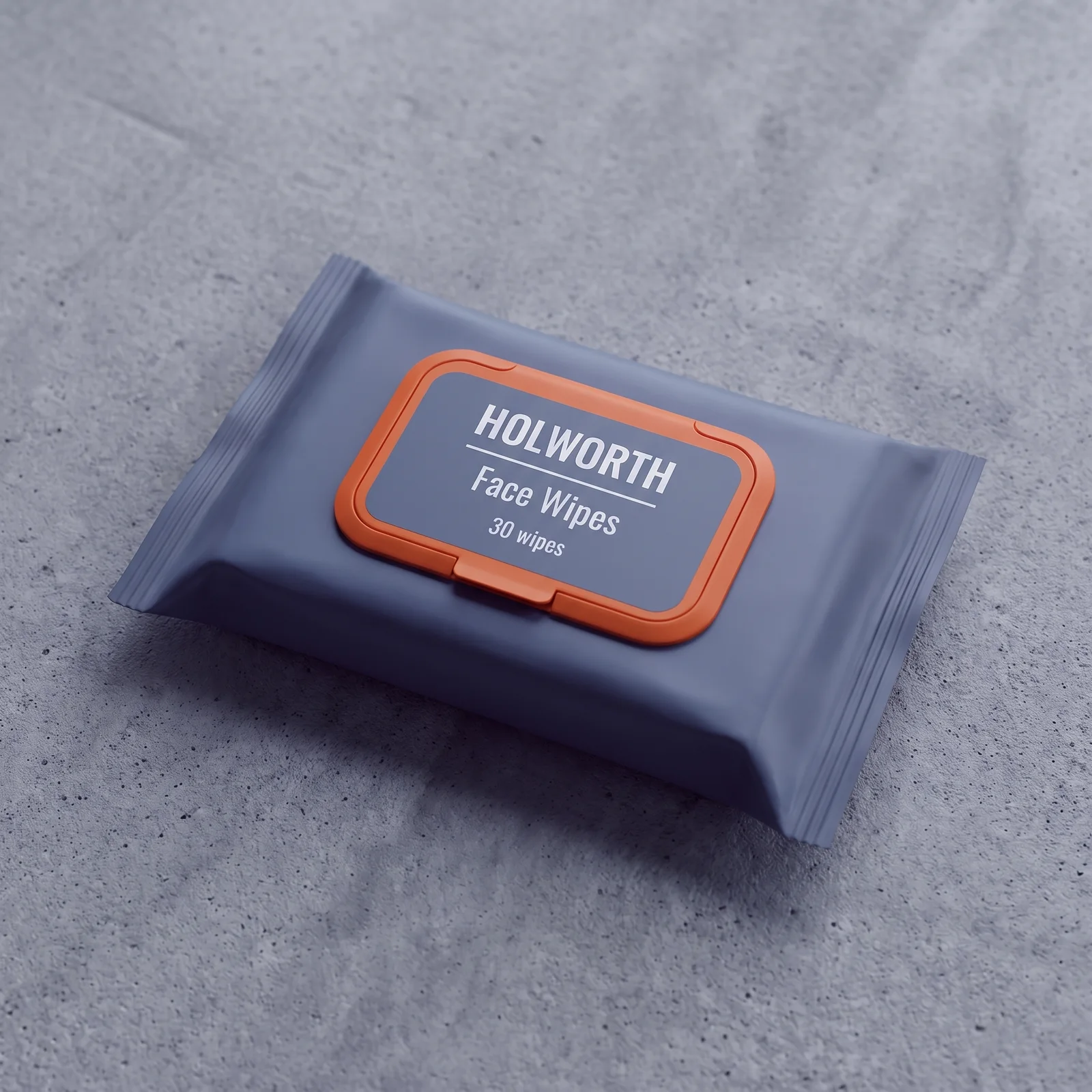 A steel-grey resealable pack of Holworth Face Wipes with an orange lid, lying on grey concrete.